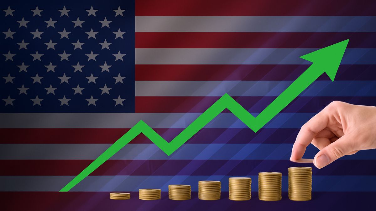 Coins stacked by a person with american flag in background